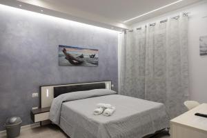 Postel nebo postele na pokoji v ubytování Pietre Azzurre Rooms