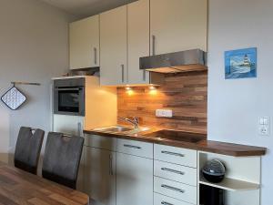 Kuchyň nebo kuchyňský kout v ubytování Meeresrauschen 16, Olhörnweg + 10 fotografií