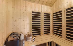 a cabin with wooden panels on the wall at Nice Home In Hemmet With Wifi in Hemmet