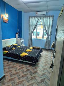 Postel nebo postele na pokoji v ubytování SR Kampar Homestay, Bandar Baru Kampar