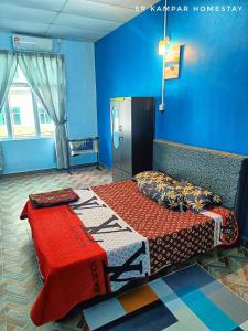 Postel nebo postele na pokoji v ubytování SR Kampar Homestay, Bandar Baru Kampar