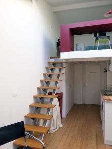 a ladder in a room with a kitchen at Mini Loft Roquette CityCosy in Paris