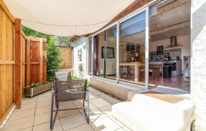 a chair sitting on a patio with a house at Amazing Apartment In Avignon With Wifi in Avignon