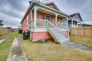 a red house with a white staircase in the yard at Less Than 3 Mi to French Quarter Pet-Friendly Home in New Orleans