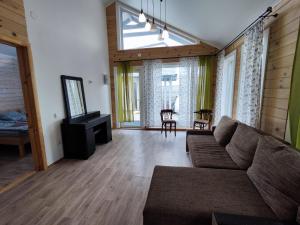 a living room with a couch and a tv at Дом Дискавери семейный у моря! in Chornomorsk