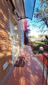 a brick walkway next to a building with a door at Stella Marina Apartment in Fregene