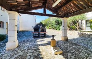 a stone patio with an outdoor grill in a building at Cozy Home In Saint-Laurent-De-La-Ca With Wifi in Saint-Laurent-de-la-Cabrerisse