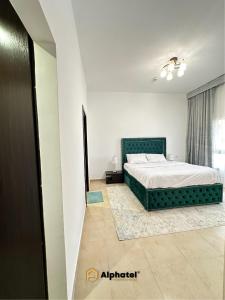 a bedroom with a large bed and a window at 2-Bedroom Holiday Home in Remraam Community - Dubai - by Alphatel Vacations in Dubai
