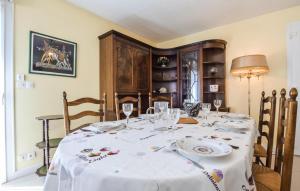 a dining room table with a white table cloth at Awesome Home In Blonville-Sur-Mer in Blonville-sur-Mer
