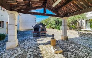an outdoor patio with a fireplace and a wooden roof at Beautiful Home In Saint-Laurent-De-La-Cabrerisse in Saint-Laurent-de-la-Cabrerisse +24 photos