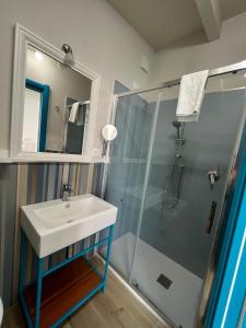 a bathroom with a sink and a shower at BURMARIA APARTMENT and ROOM with garden and jacuzzi in Tropea +50 photos