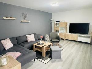 a living room with a couch and a tv at Holla die Waldfee in Königerode