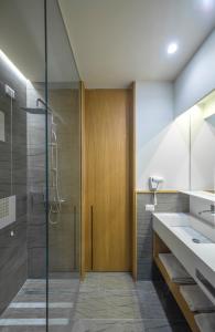 a bathroom with a shower and a glass door at Gaura Apartments in Trapani