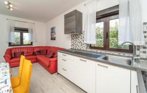 a kitchen with a red couch and a red couch at 2 Bedroom Lovely Apartment In Rtina in Rtina