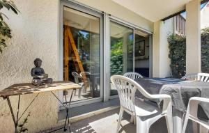 a table with a statue on it on a patio at 1 Bedroom Amazing Apartment In Carnac in Carnac +5 photos
