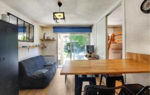 a living room with a table and a blue couch at 1 Bedroom Amazing Apartment In Carnac in Carnac