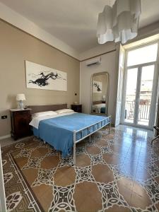 a bedroom with a bed and a large mirror at L'Una di Notte in Salerno