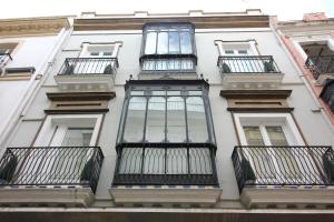 a building with balconies on the side of it at Las Atarazanas - Design Hostal in Seville