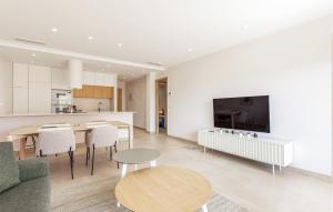 een keuken en een woonkamer met een tafel en een televisie bij Nice Apartment In Torre De La Horadada in Torre de la Horadada