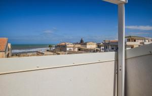 a view of the beach from the balcony of a house at Cozy Apartment In Santa Croce Camerina in Santa Croce Camerina