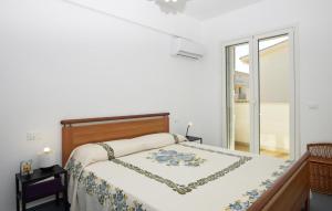a bedroom with a bed with a chain on it at Cozy Apartment In Santa Croce Camerina in Santa Croce Camerina