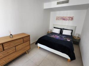 a bedroom with a bed and a wooden dresser at Appartement Nice Carré d Or in Nice