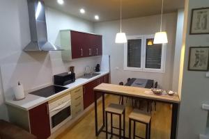 a kitchen with a counter and a table with chairs at Casa Aurora in Vecindario