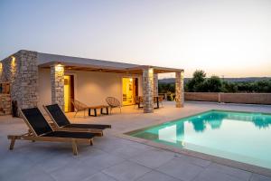 a patio with a swimming pool and a house at Kastri Hill Luxury Villas in Palekastron