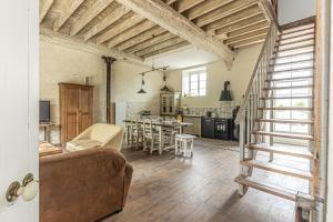 a large living room with a couch and a kitchen at Chez Marguerite et Bienaimé in Picauville