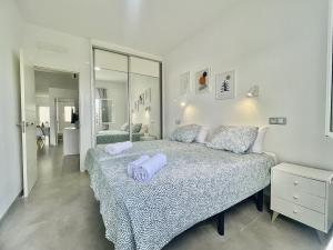 a bedroom with a bed with two towels on it at Bright Place Bungalow in San Bartolomé +38 photos