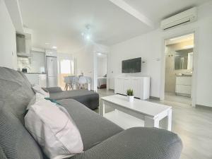 a living room with a couch and a table at Bright Place Bungalow in San Bartolomé