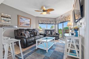 a living room with a couch and a table at Sunrise Resort 209 in St Pete Beach