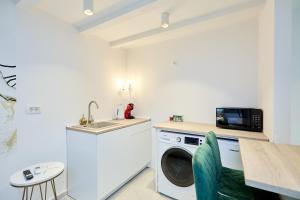 a kitchen with a washing machine and a sink at Karma Suites by Dominium in Dubrovnik