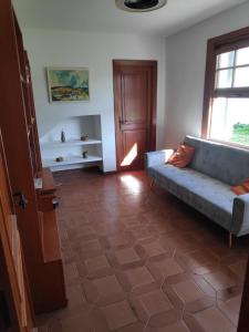 a living room with a couch on a tile floor at La Casa del Sol in La Eliana