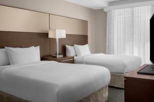 a hotel room with two beds and a window at Residence Inn by Marriott Santa Clarita Valencia in Santa Clarita