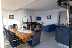 a dining room with a wooden table and chairs at Salamina Blue Horizon House in Eantio