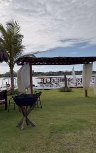 an outdoor area with a umbrella and a table and a tree at Apart Resort Catu Lake Catu Like in Aquiraz