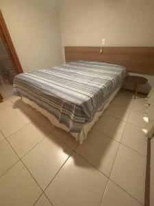 a bed sitting on a tiled floor in a room at Apart Resort Catu Lake Catu Like in Aquiraz +26 photos