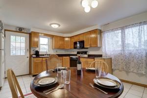 a kitchen with a wooden table and a dining room at Getaway Near ORD With Great Local Amenities in Des Plaines +7 photos