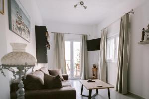 a living room with a couch and a table at Kampos Bliss Apartments in Votsalákia