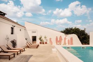 a patio with chairs and a swimming pool at O Val farmhouse in Monforte