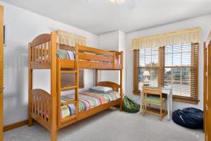 a bedroom with a bunk bed and a desk at W13 Wedges 13 in Nags Head