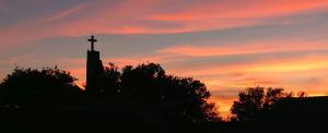 a cross on top of a building at sunset at House Munich - Montenegro in Donji Štoj
