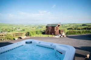 a hot tub on the side of a house at The Scotch Rock in Castlewellan