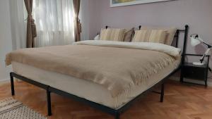a bed in a bedroom with at Helen Apartament in Craiova