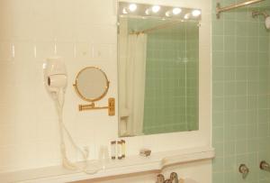 a bathroom with a shower with a mirror and a sink at Travels Inn Victoria County in Boularderie East +112 photos