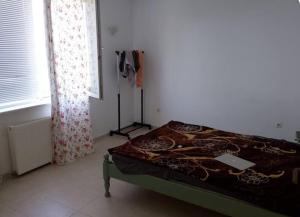 a bedroom with a bed in a room with a window at Wild house Goriza in Goritsa