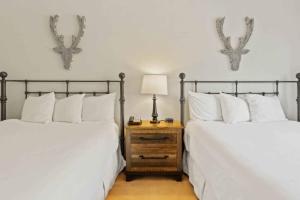 two beds sitting next to each other in a bedroom at The Charter at Beaver Creek D455 in Beaver Creek