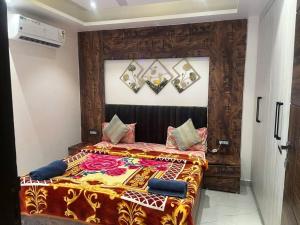a bedroom with a bed with a colorful blanket at Entire Floor Luxury 3BHK 3Baths 5 Double Beds in Tapovan Nr Laxman Jhulla in Rishīkesh