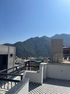 a balcony of a building with mountains in the background at Entire Floor Luxury 3BHK 3Baths 5 Double Beds in Tapovan Nr Laxman Jhulla in Rishīkesh